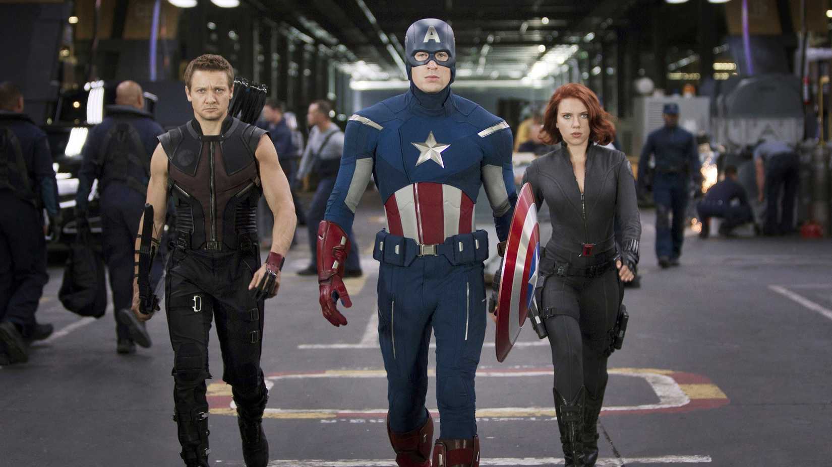 Hawkeye (Jeremy Renner), Captain America (Chris Evans), and Black Widow (Scarlett Johansson) looking serious and walking together in The Avengers (2012)
