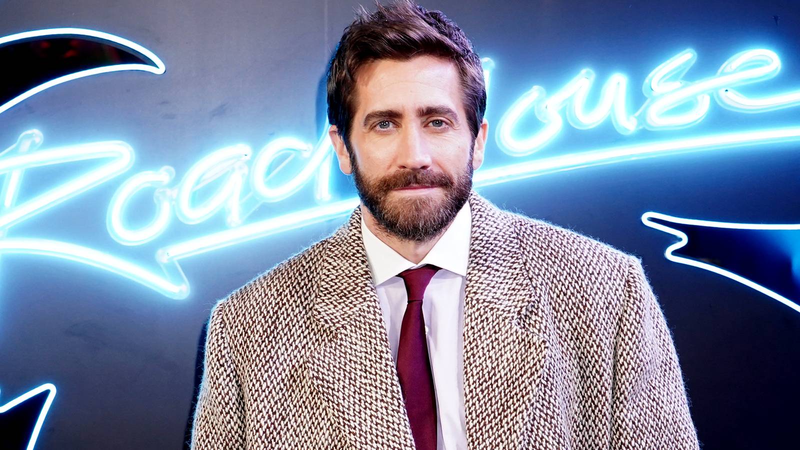 Jake Gyllenhaal posing for a photo at a Road House event