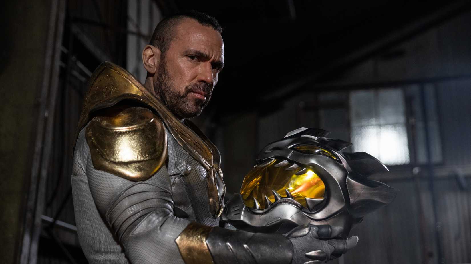 Jason David Frank holds the White Dragon helmet in Legend of the White Dragon