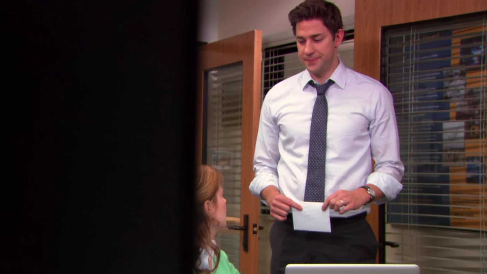 Jim (John Krasinski) handing a letter to Pam (Jenna Fischer) in The Office, AARM