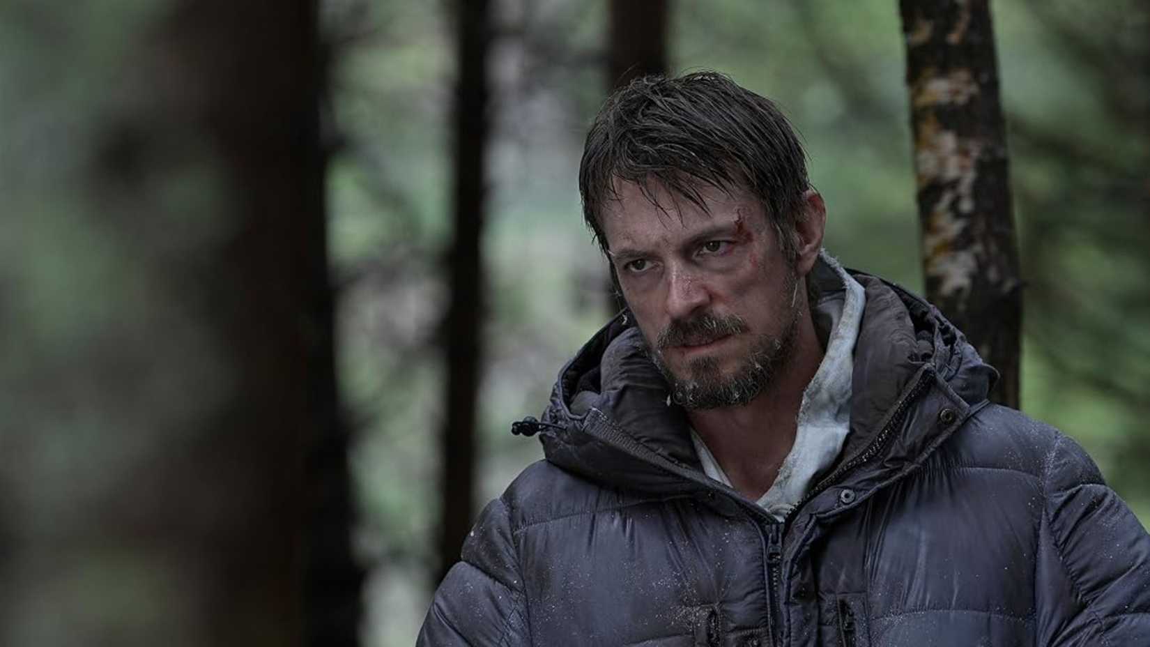 Joel Kinnaman looking tired in the woods in Icefall