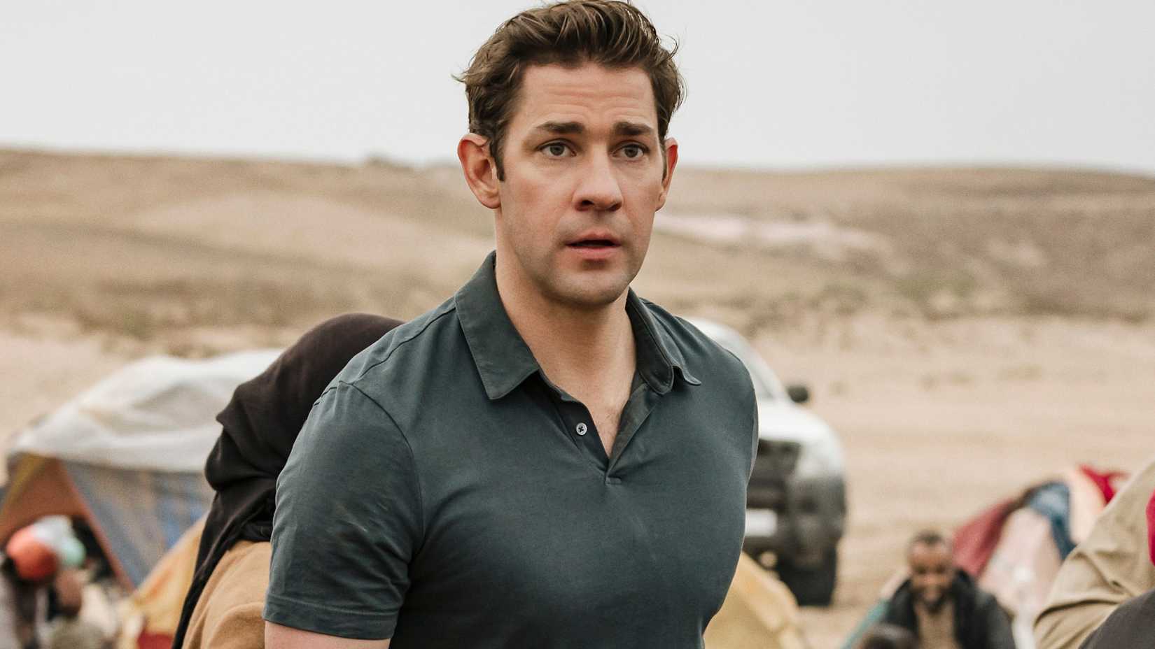 John Krasinski as Jack Ryan on a beach.