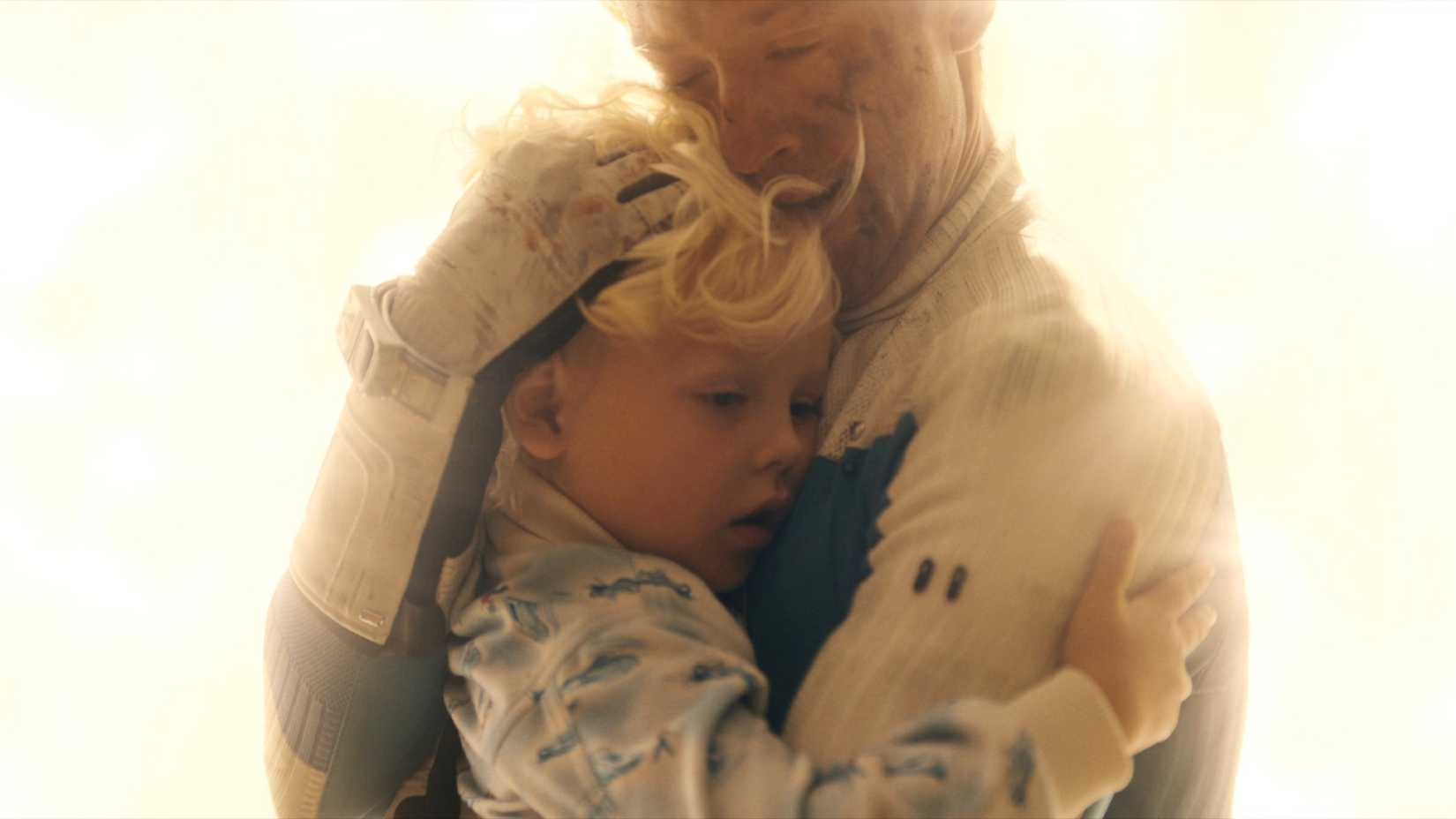 Joseph Quinn as Johnny Storm holding Franklin Richards in Avengers: Doomsday