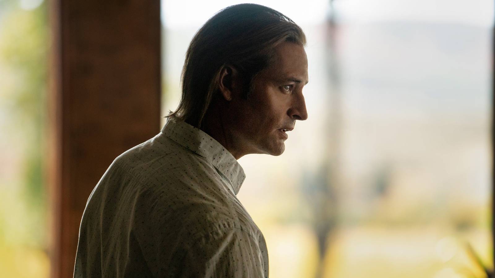 Josh Holloway peers forward dramatically in profile in a scene from Yellowstone