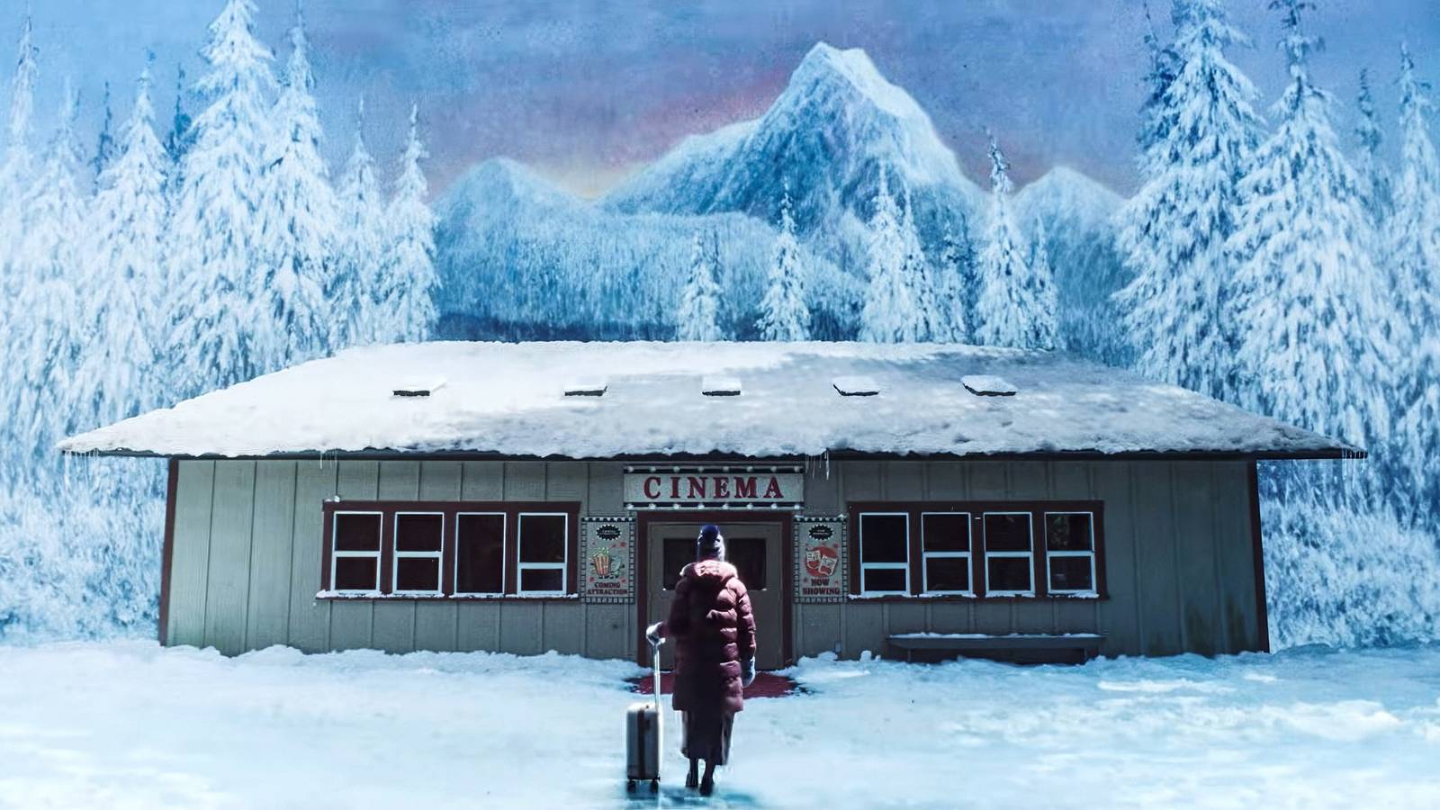 Kris with a suitcase standing before Billy's private movie theater in Teenage Sex and Death at Camp Miasma