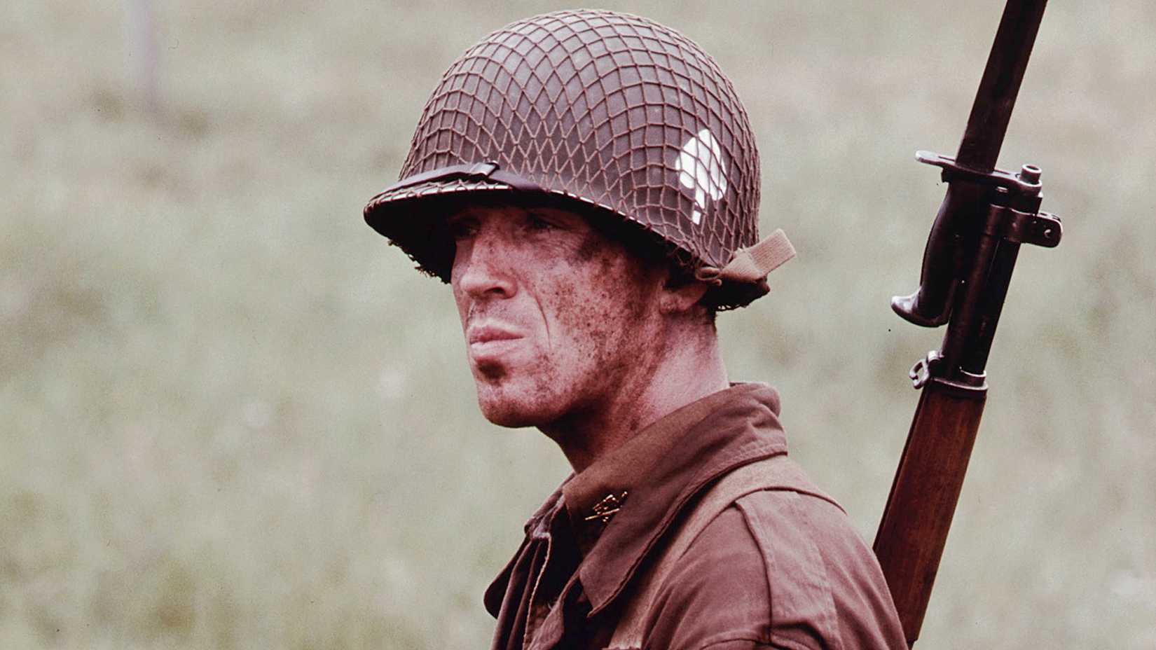 Luke Roberts has a rifle on his back in Band of Brothers