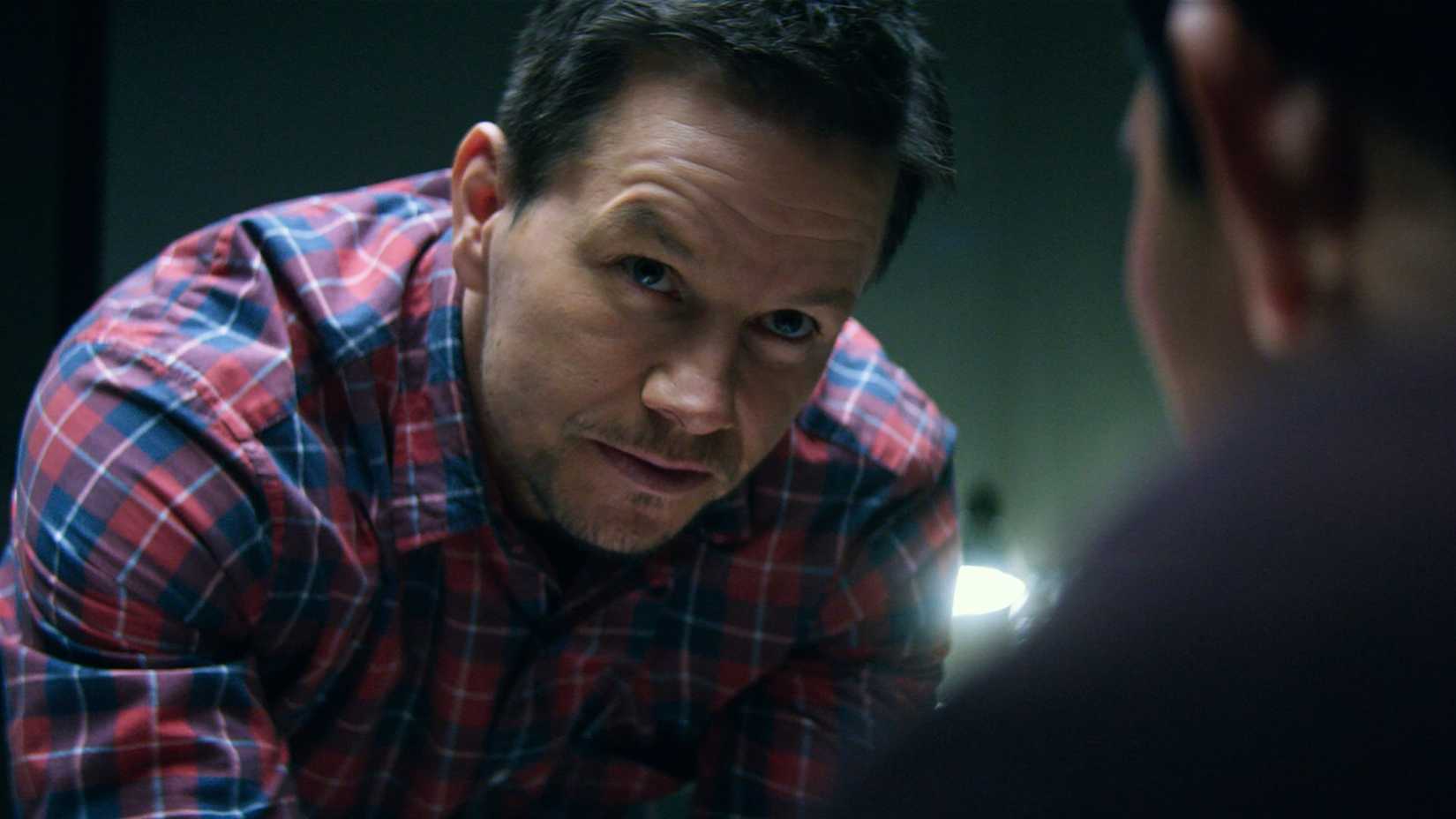 Mark Wahlberg as James Silva talking to someone in Mile 22