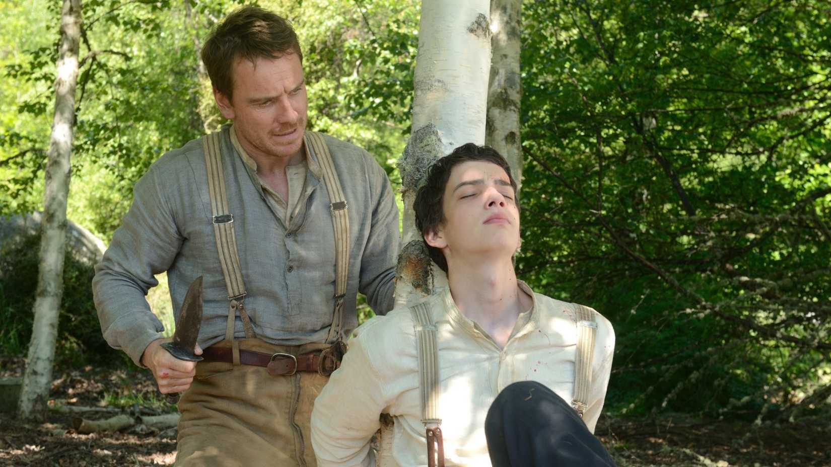 Michael Fassbender as Silas freeing Kodi Smit-McPhee as Jay in Slow West
