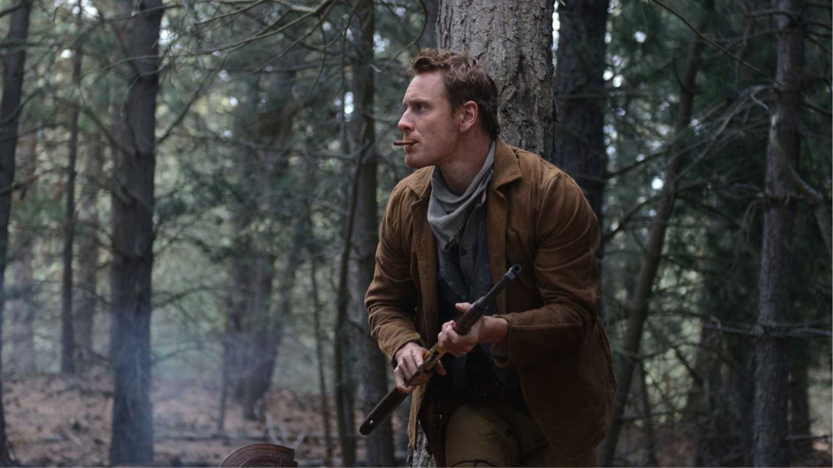 Michael Fassbender running with a gun as Silas in Slow West