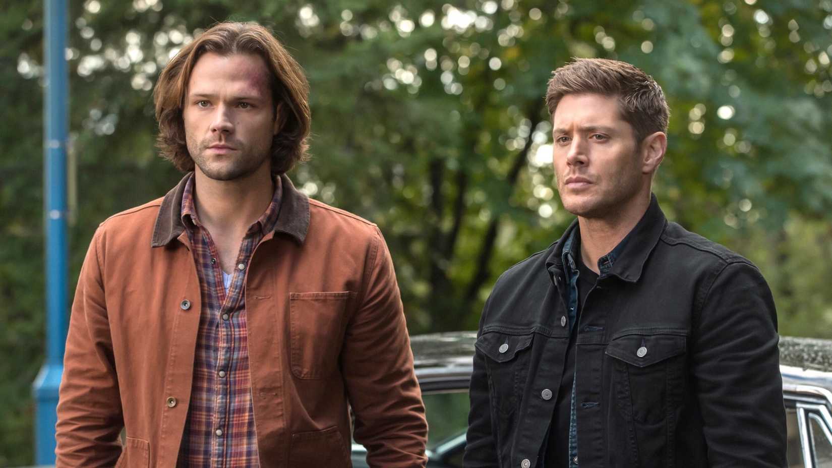 Sam and Dead standing in front of the Impala in Supernatural season 13