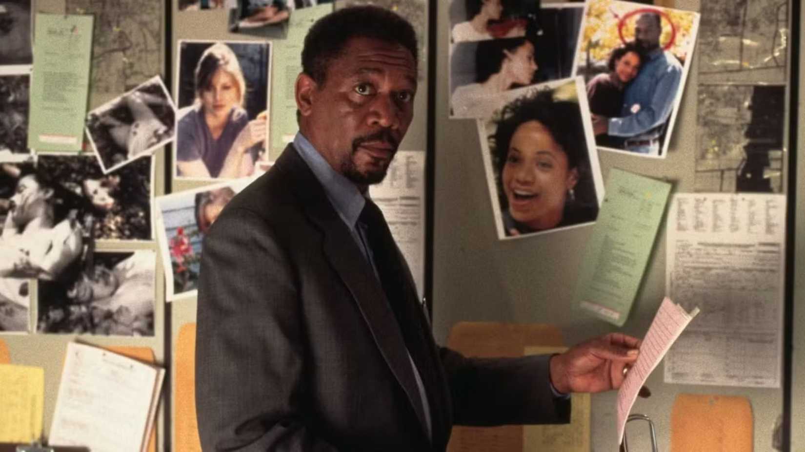 Morgan Freeman as Alex Cross looking at pictures in Kiss the Girls