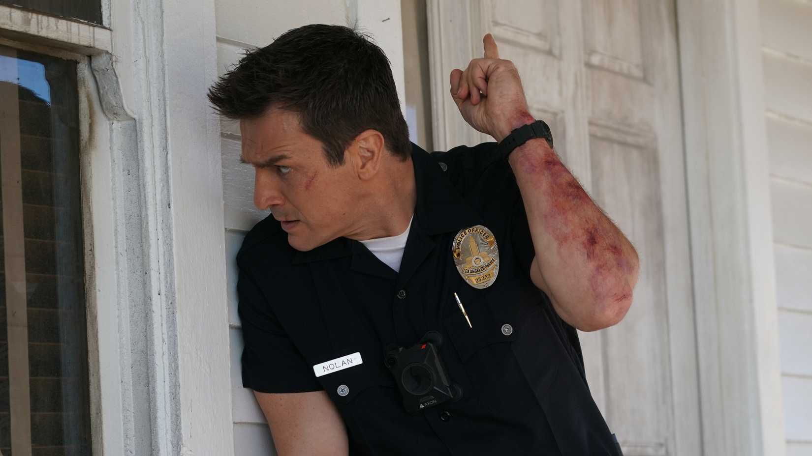 John Nolan about to enter a reidence in The Rookie.