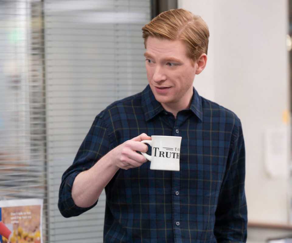 Ned with a mug in The Paper