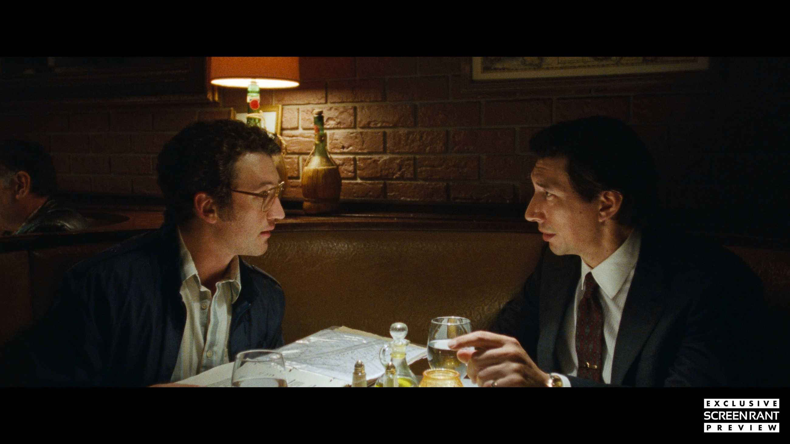 Miles Teller and Adam Driver sitting in a restaurant booth in Paper Tiger