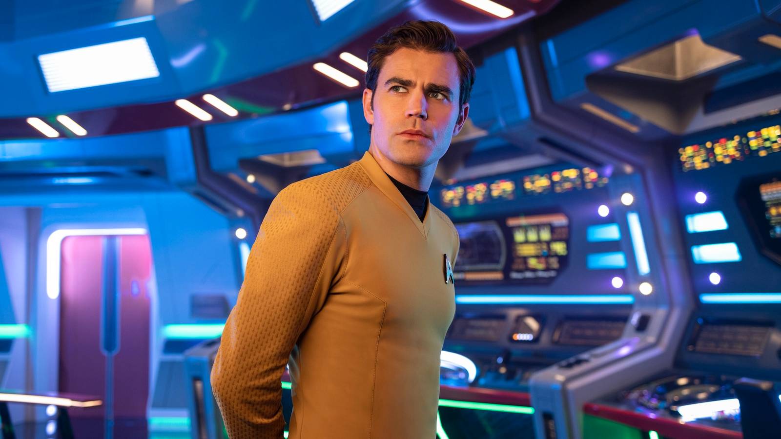 Paul Wesley's Kirk standing on the bridge of the Enterprise