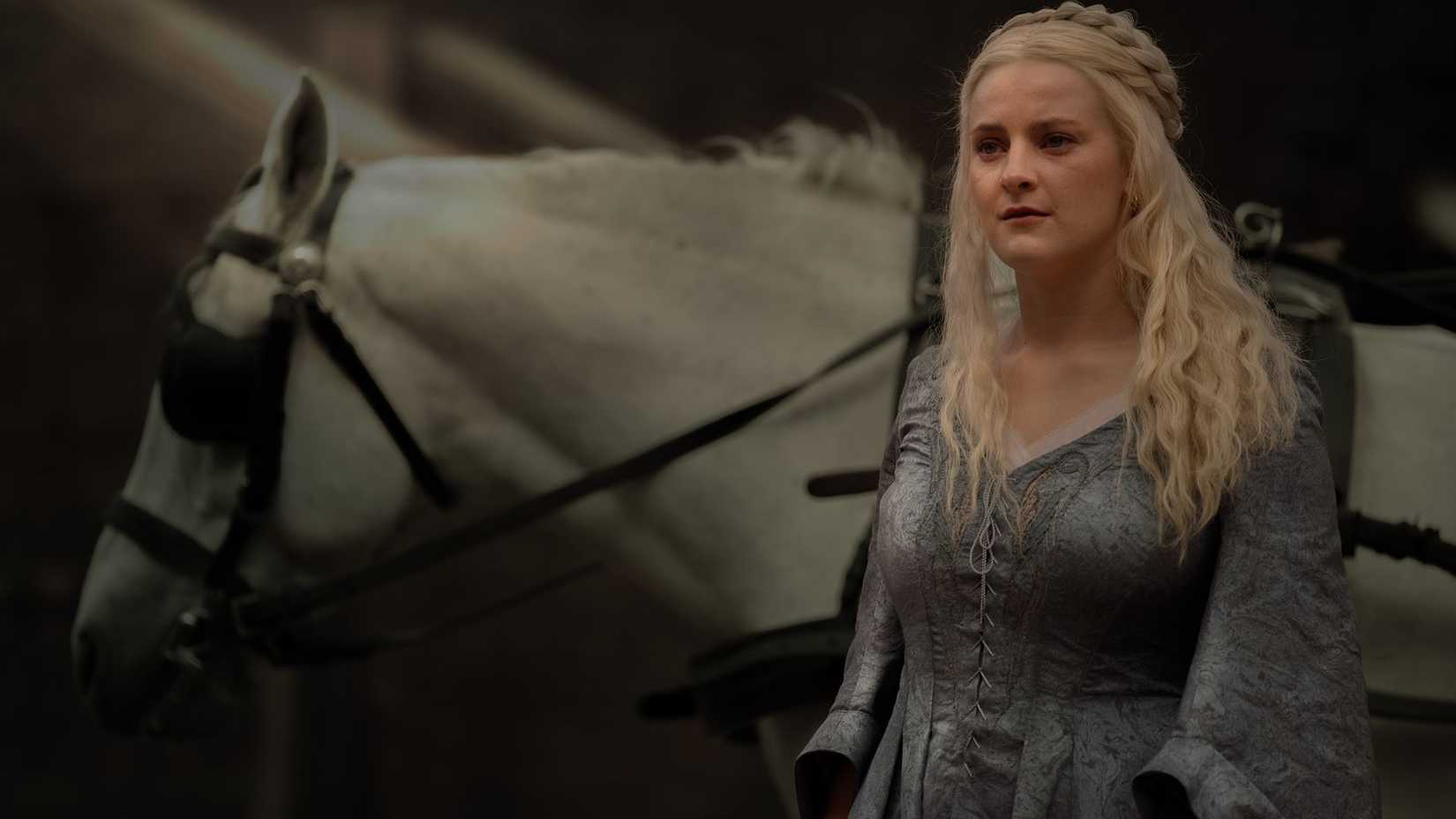 Helaena looking curious by a grey mare in House of the Dragon