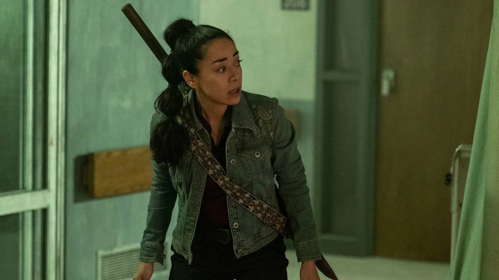 Renata worriedly looking around a corner in The Walking Dead Dead City Season 3 Episode 3