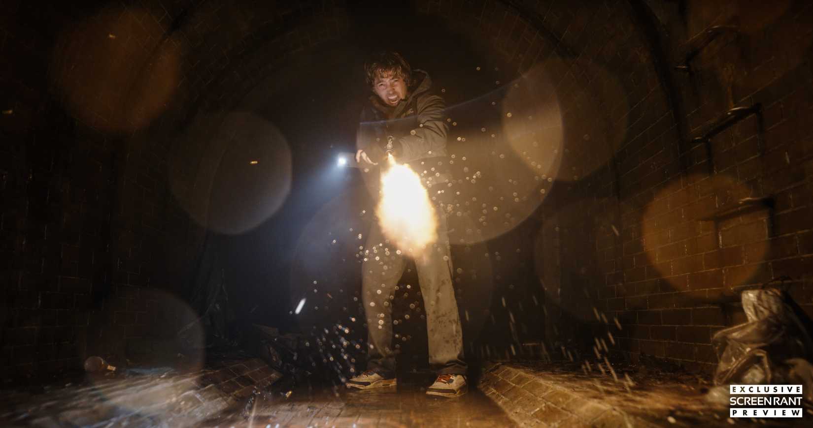 Austin Abrams screaming and firing a gun toward camera in Resident Evil