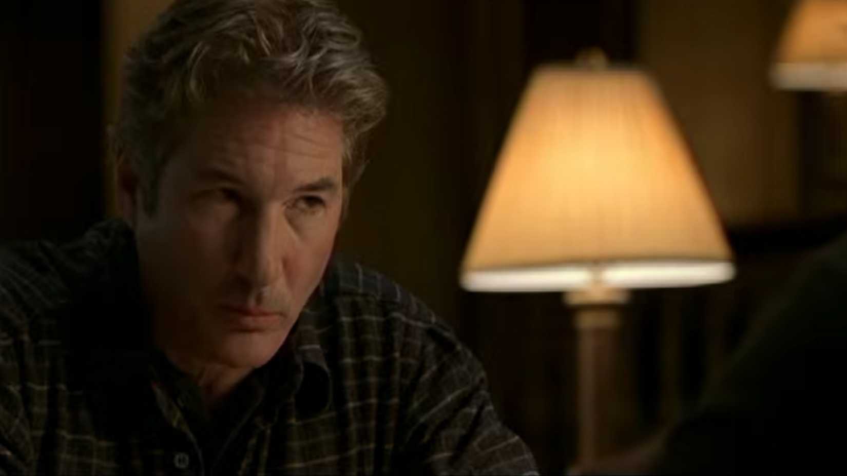 Richard Gere looking confused listening to someone talk in The Mothman Prophecies
