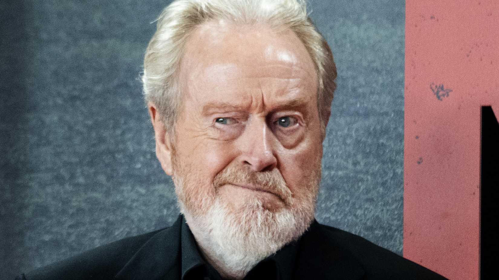Ridley Scott posing on a red carpet