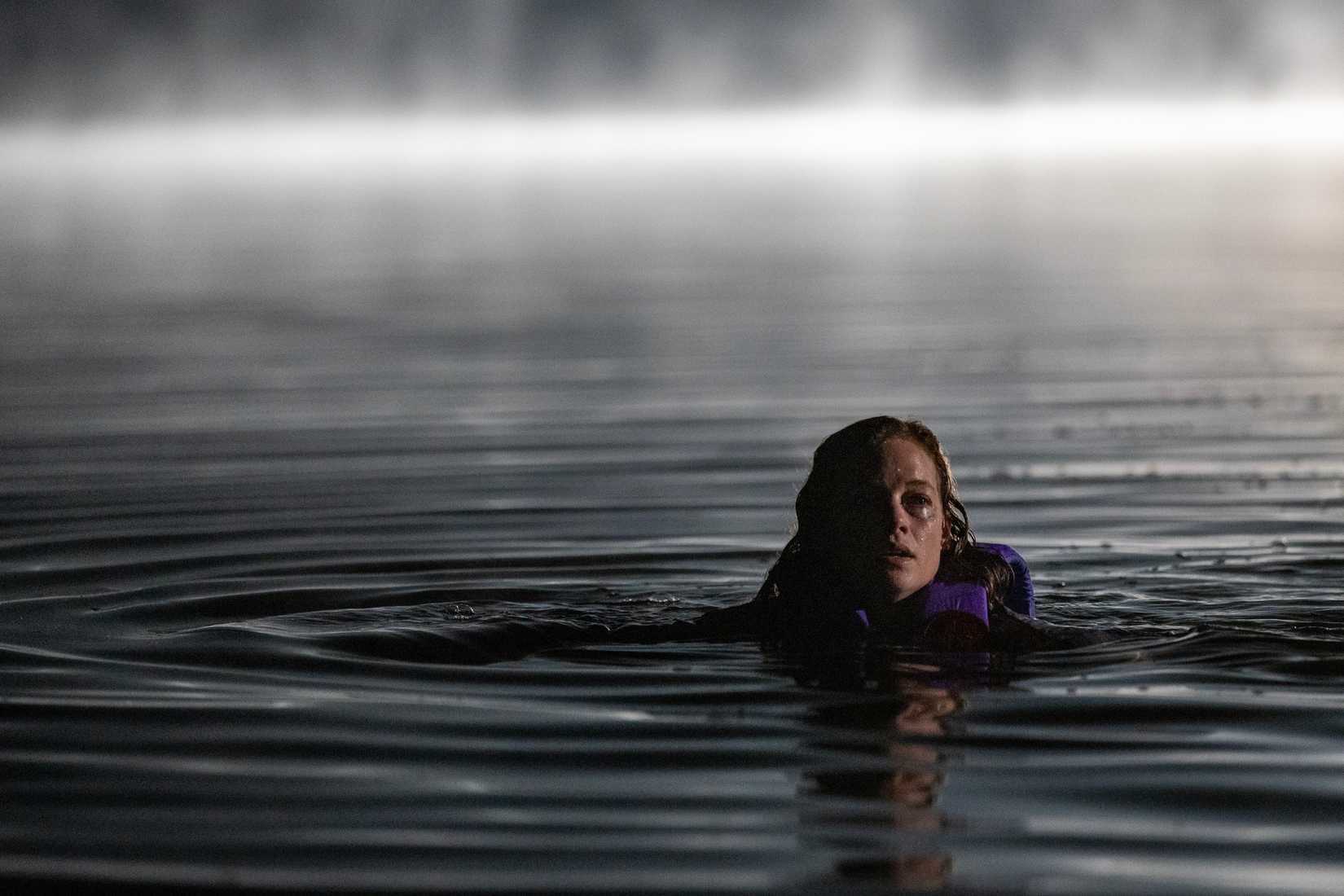 A woman with a lifejacket floating in the water in River