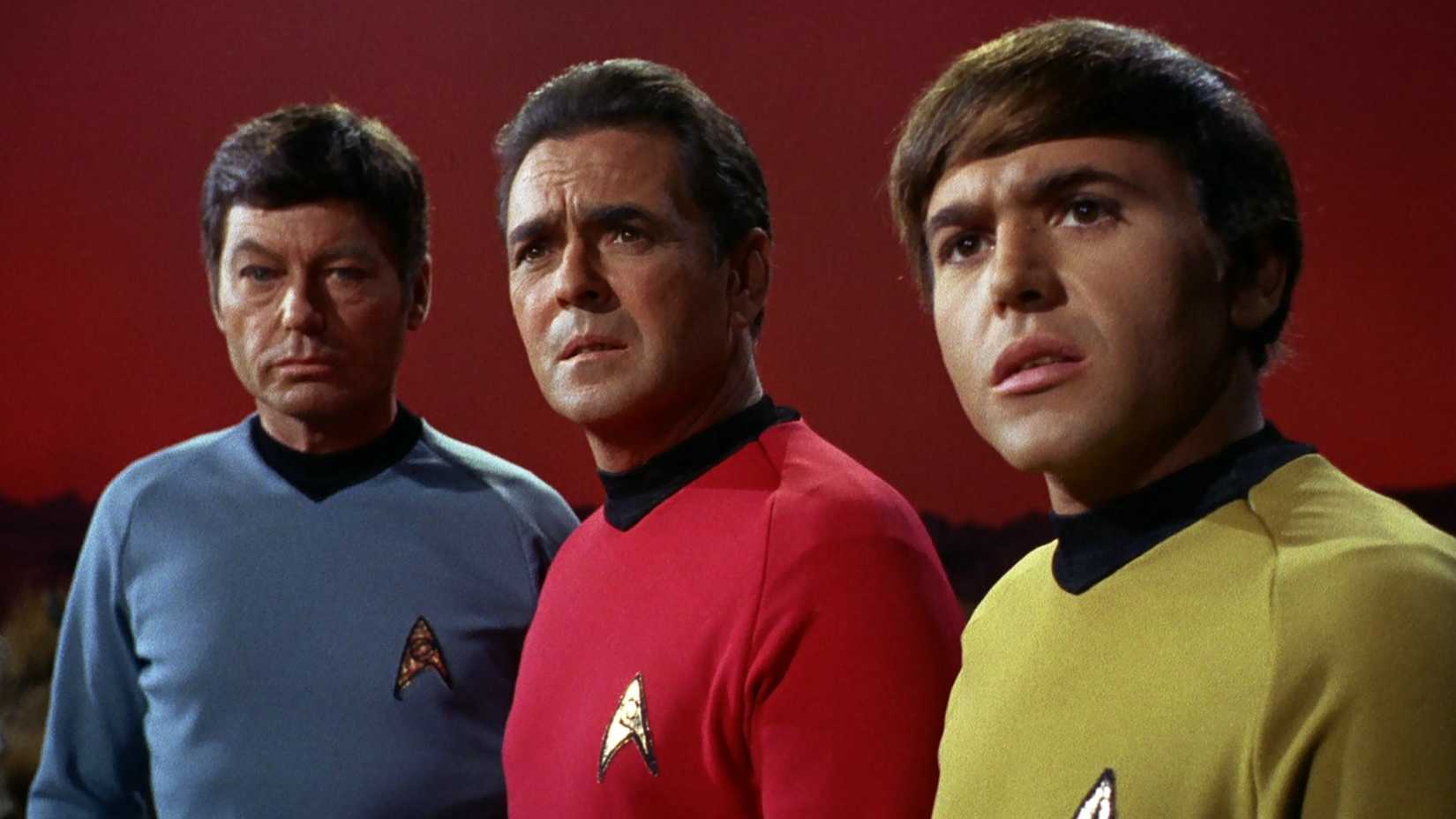 McCoy, Scotty, and Chekov look on in the Star Trek episode Specter of the Gun