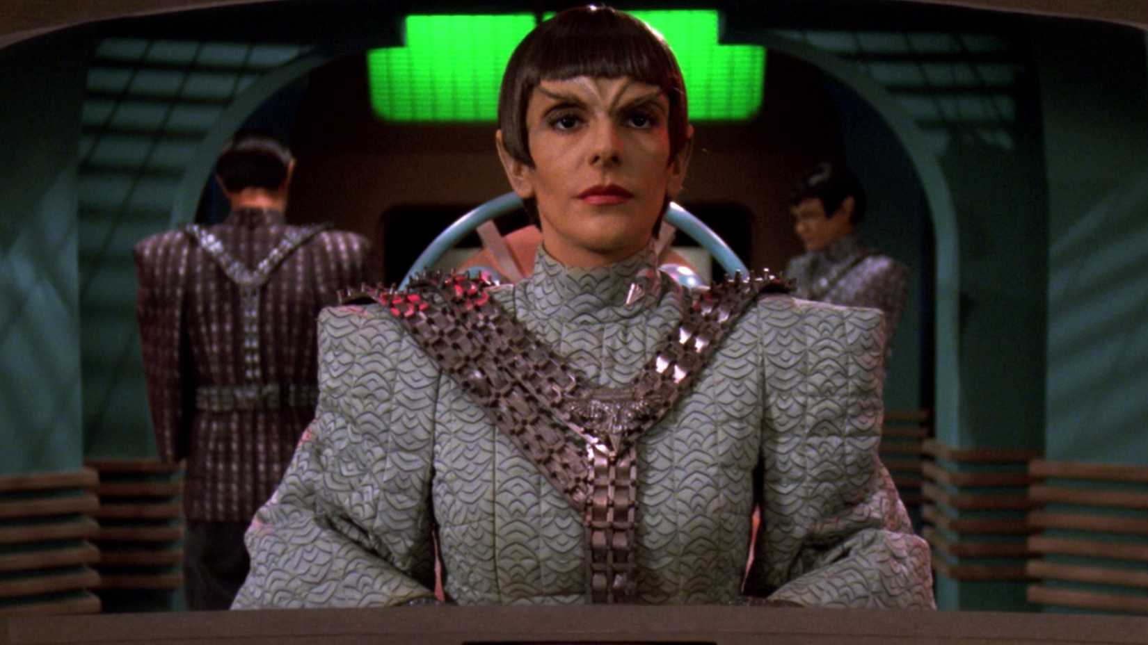 Deanna Troi looks on as a Romulan in Star Trek The Next Generation
