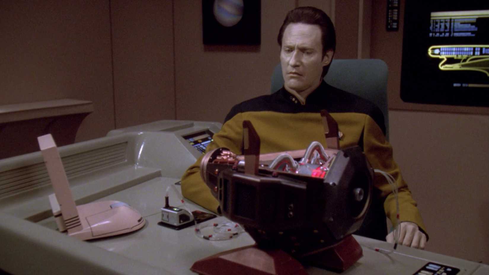 Data looks confused at an Exocomp probe in Star Trek The Next Generation