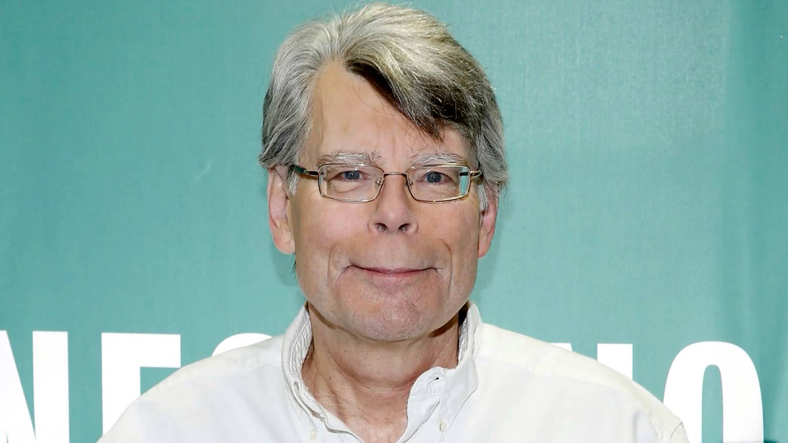 Stephen King smiling for a photo at an event