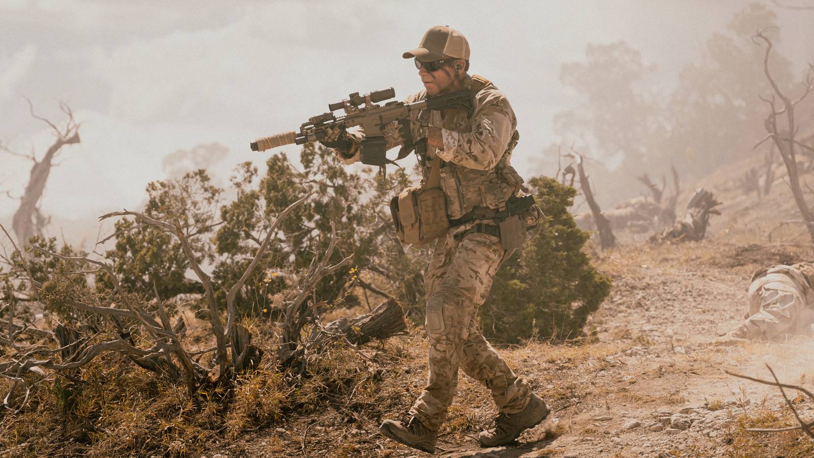 Taylor Sheridan as Cody, holding a gun in Lioness