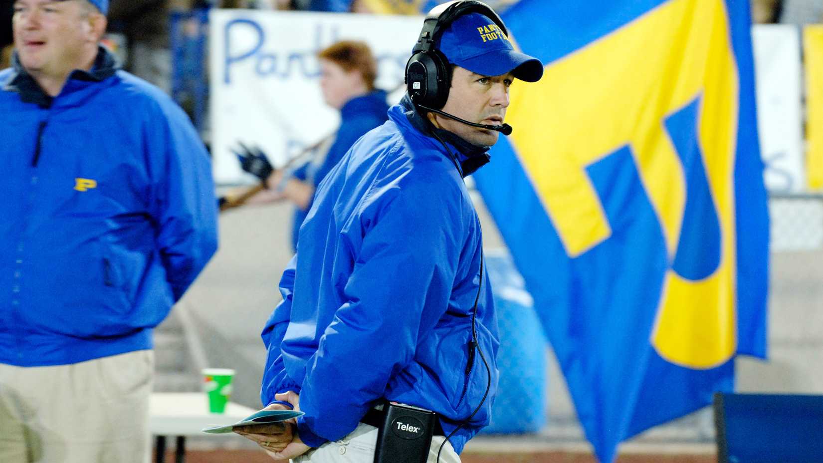 Still of Kyle Chandler as Coach Eric Taylor walking on the field in Friday Night Lights.