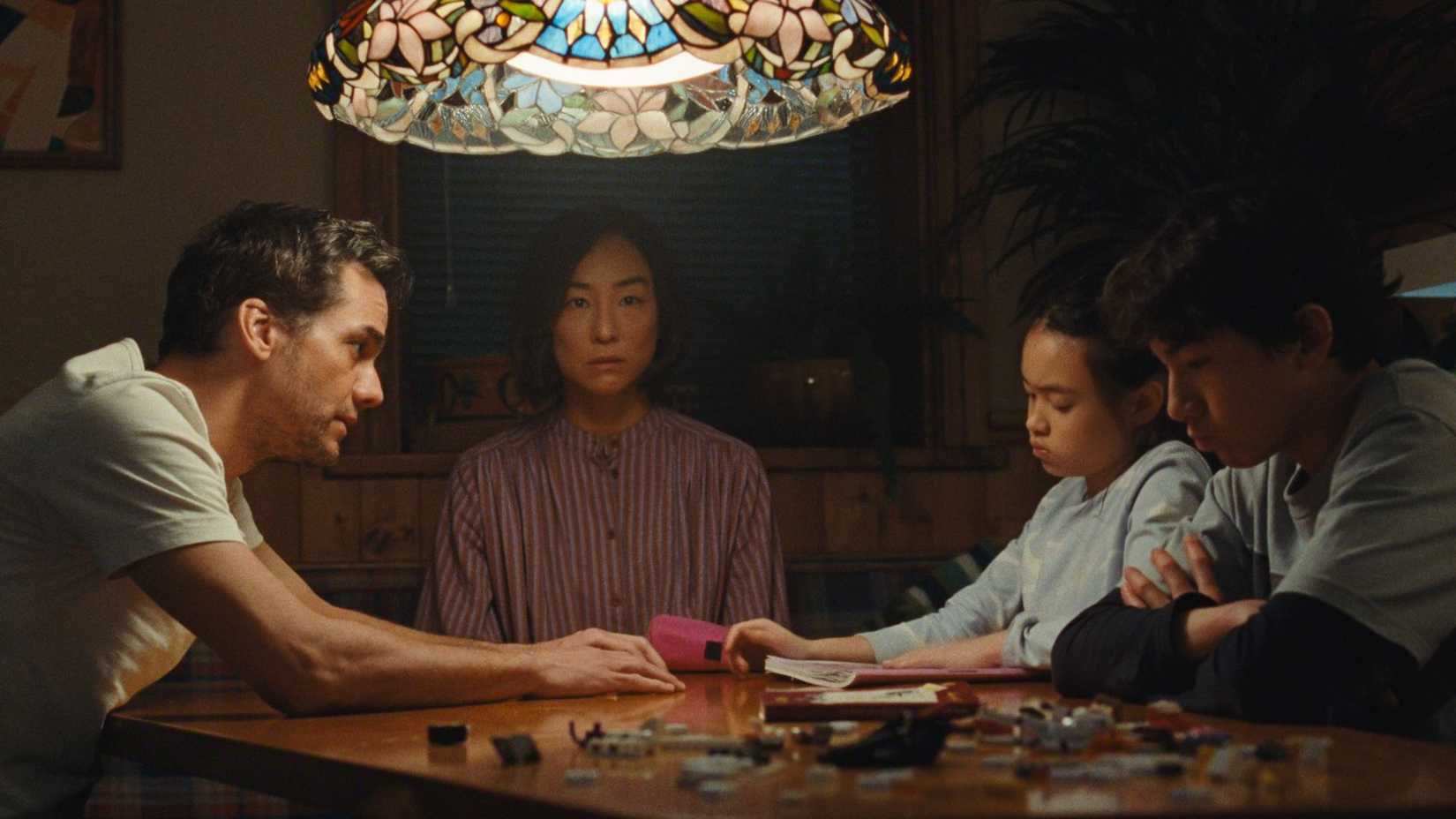 The family sitting around a table in The Last House