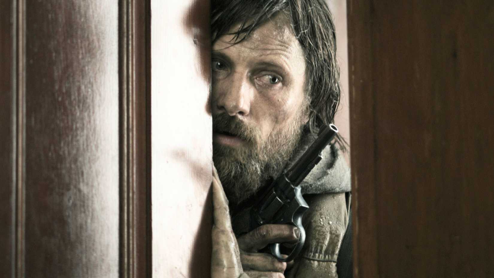 The Father peering through a doorway in The Road