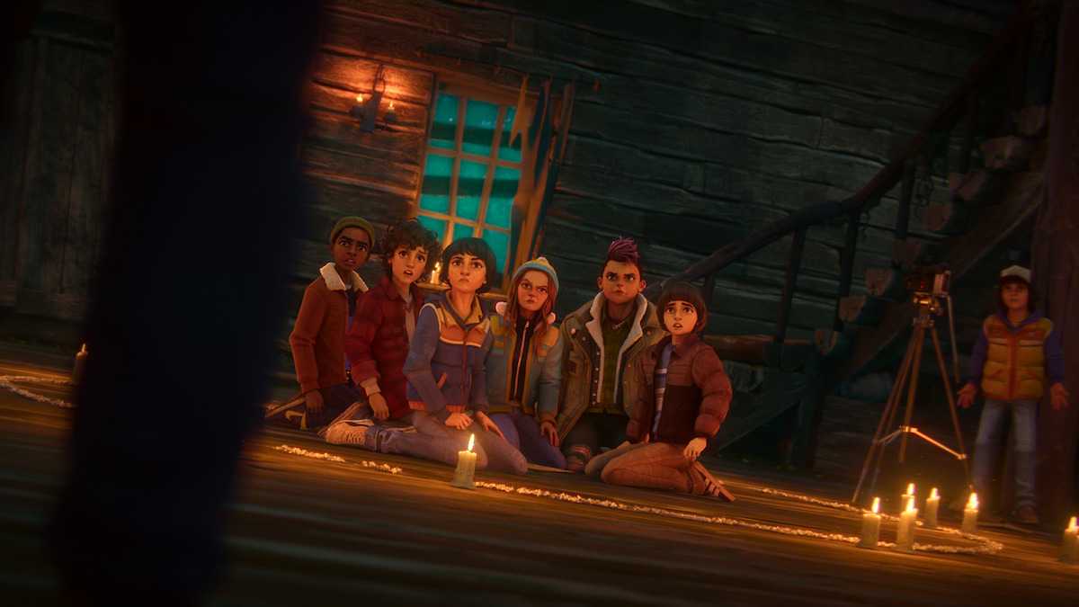 The group looking at an unseen character while sitting on a cabin floor in Stranger Things: Tales from '85