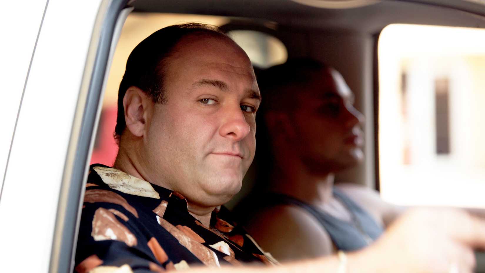 Tony (James Gandolfini) looking out a car window with someone driving him in The Sopranos.