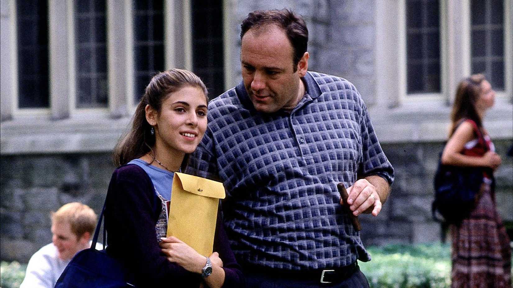 Meadow (Jamie-Lynn Sigler) smiling with Tony (James Gandolfini) as they tour a college in The Sopranos season 1 episode, College.