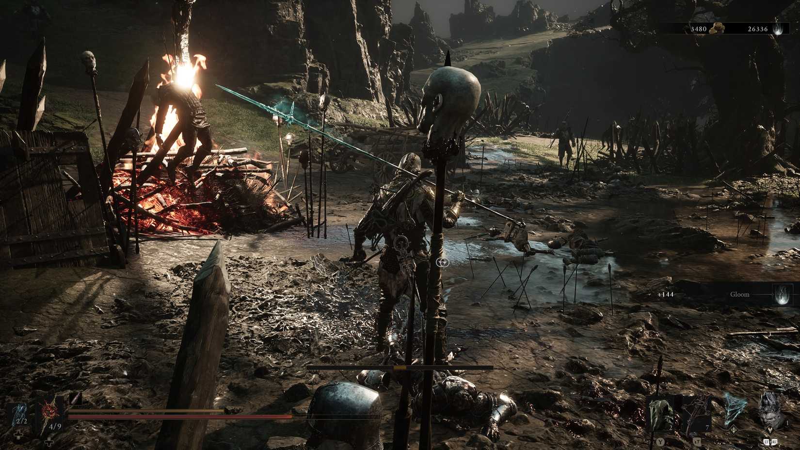 Tiel stands by a bonfire in a field of post-war gore in Mortal Shell II