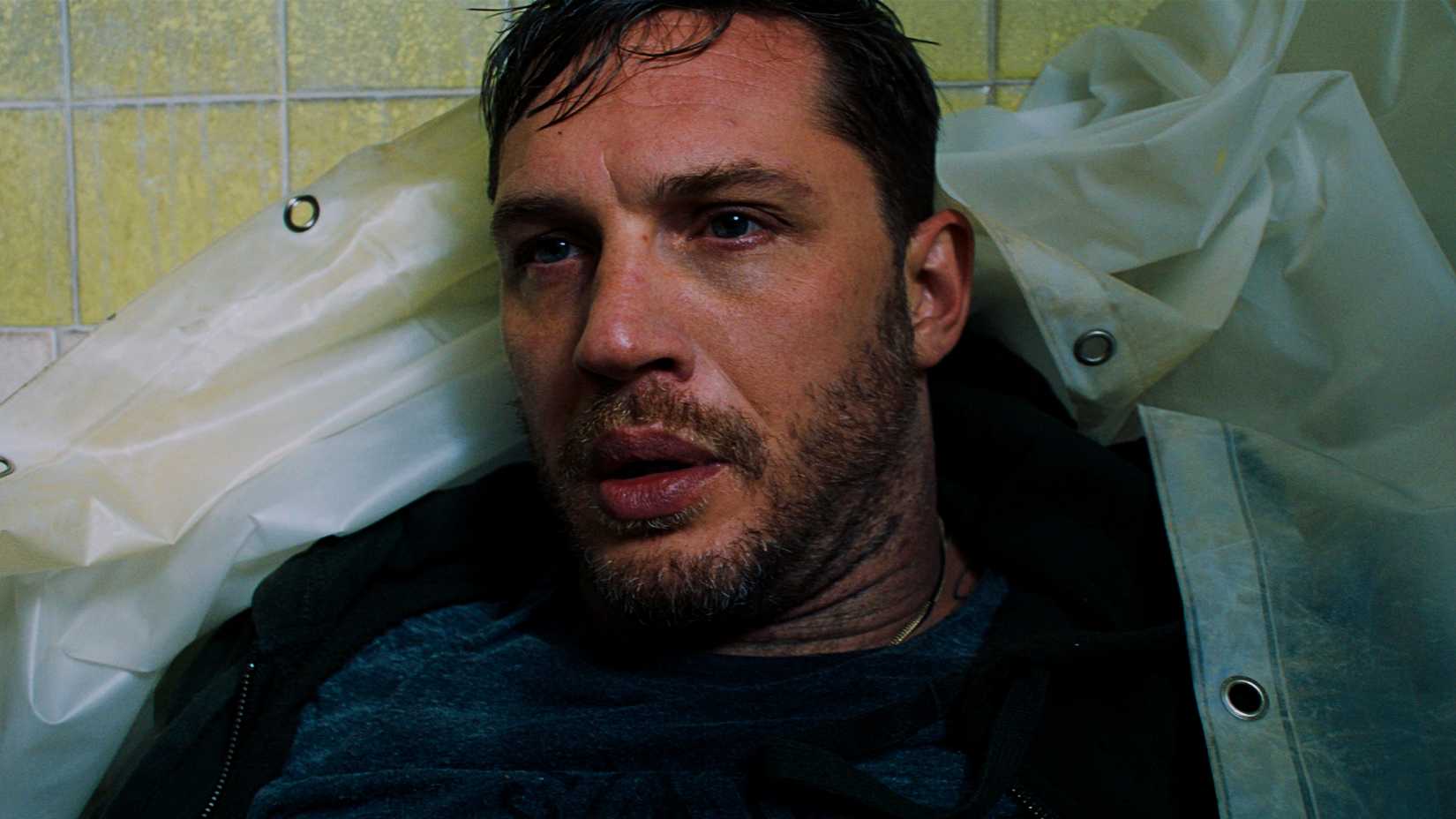 Tom Hardy's Eddie Brock looking lost with shower curtains over him in Venom
