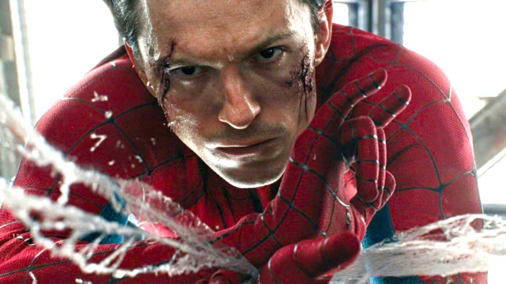 Tom Holland as Spider-Man shooting webs with a bloodied face in Brand New Day