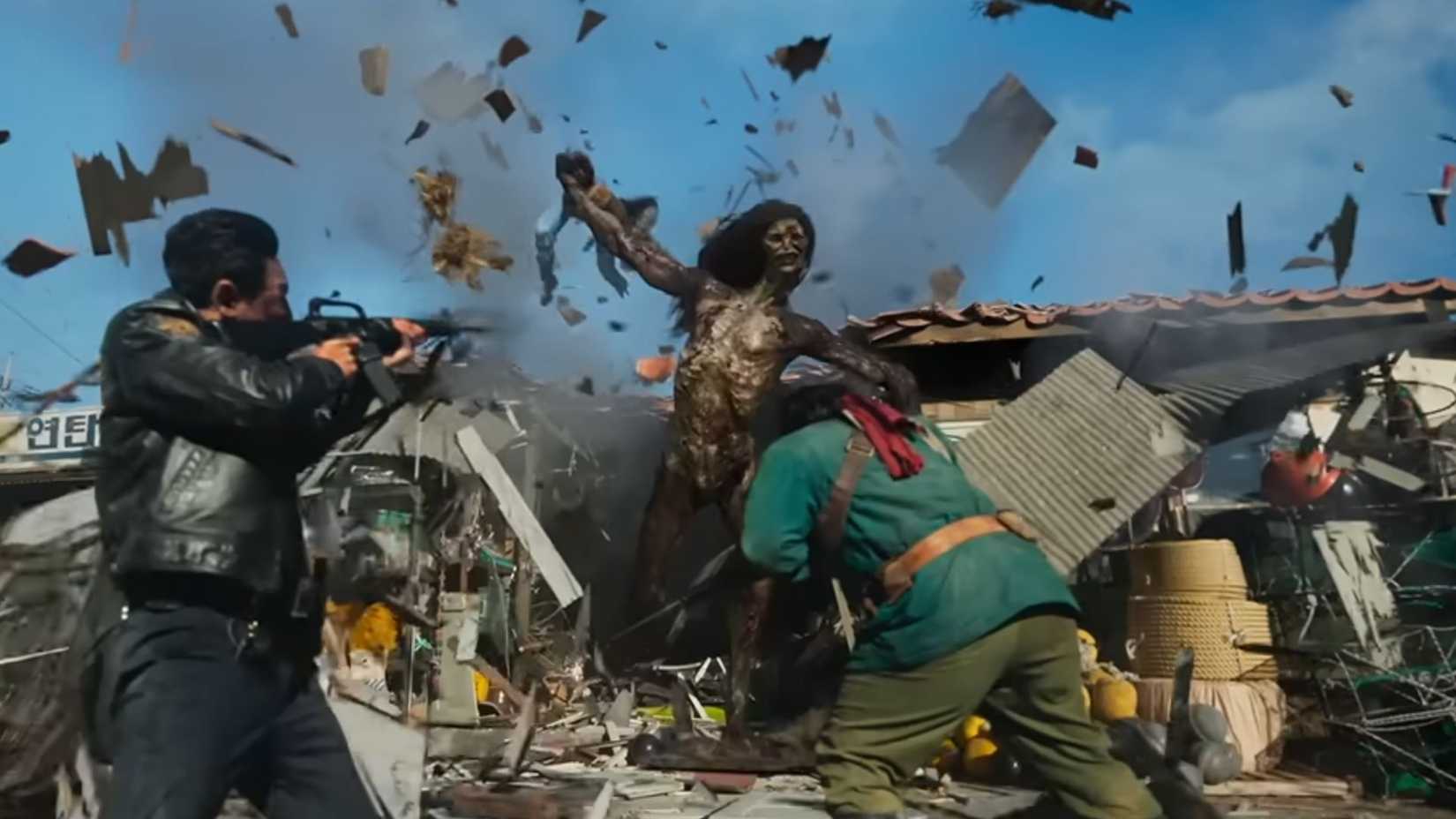 The monster bursting through a building, throwing debris in a screenshot from the Hope trailer