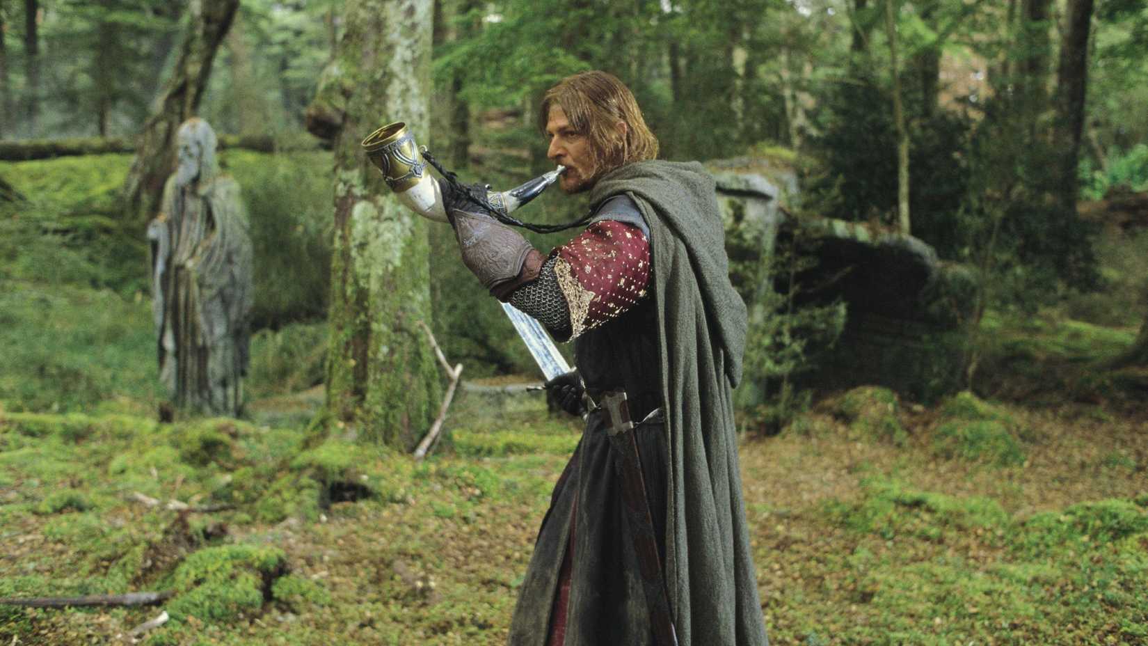 Boromir holding a sword and blowing the horn of Gondor