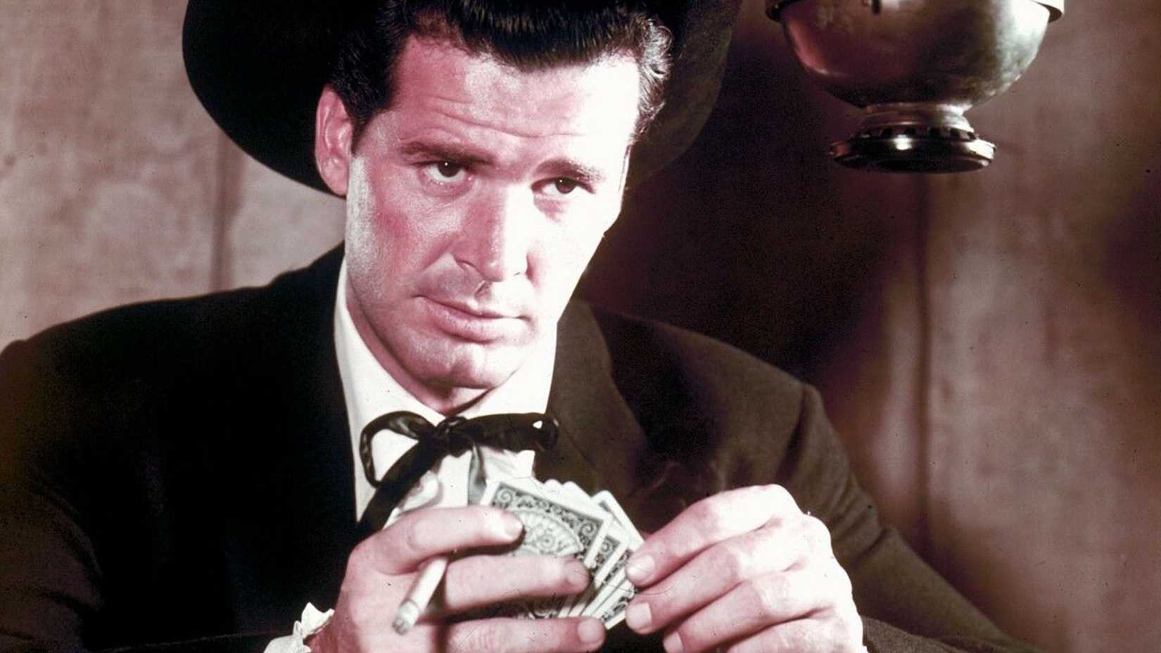 James Garner as Bret Maverick, holding money and a cigarette
