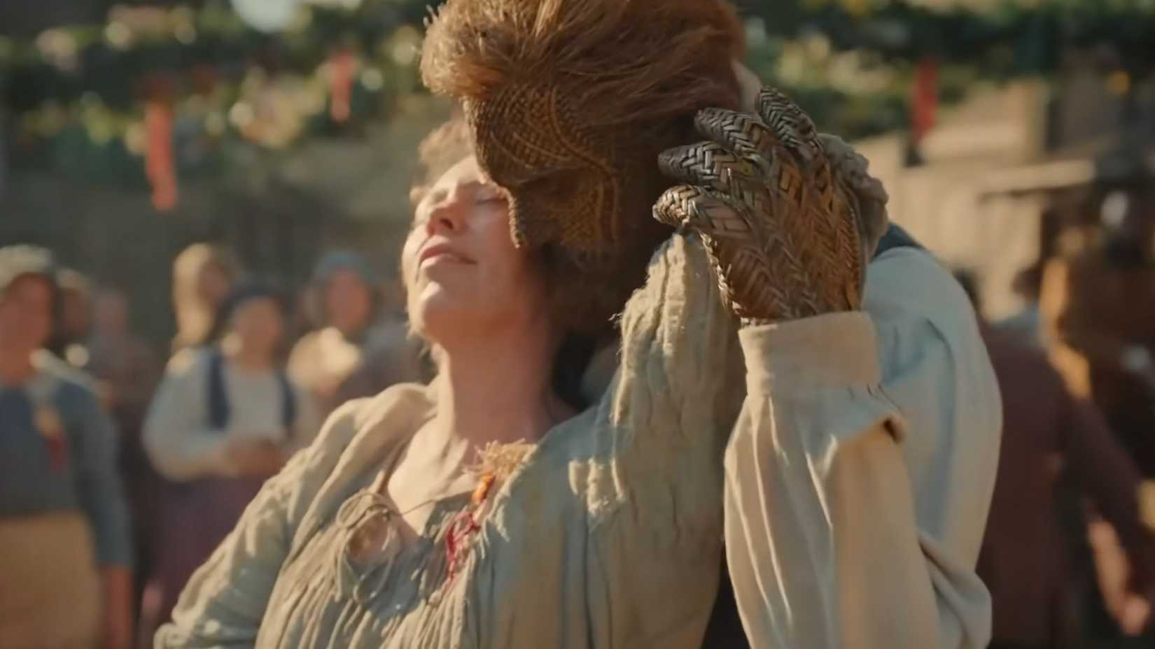 Olivia Colman and Alexander Skarsgard embracing in a dance