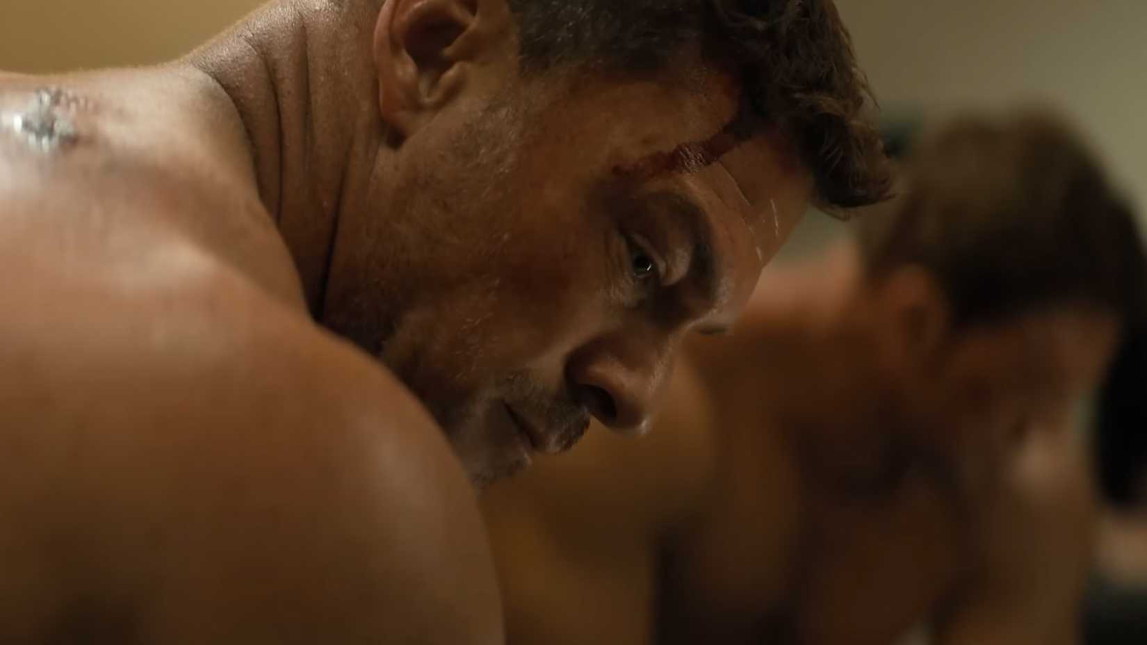 Reacher's bloodied face in profile