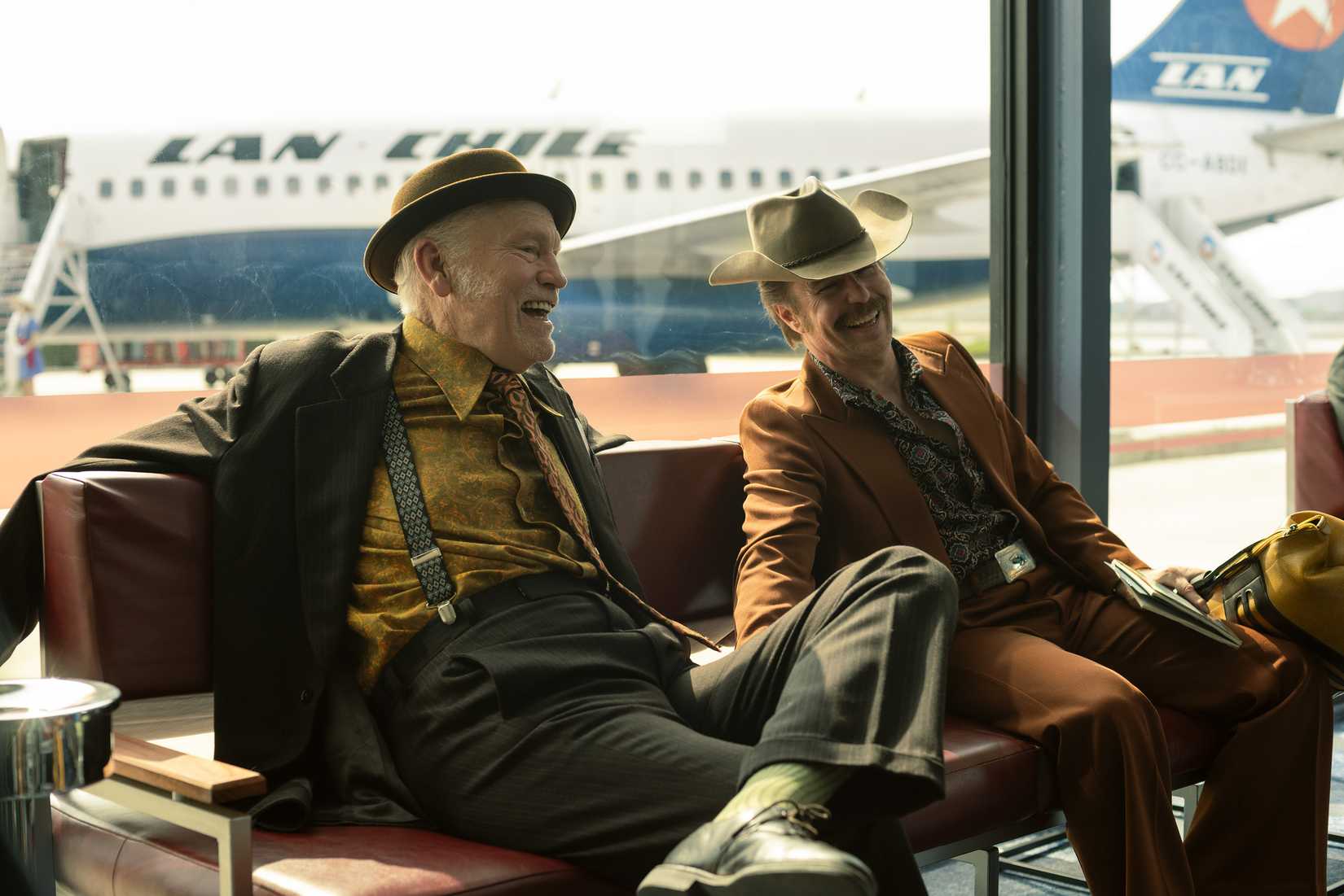 John Malkovich and Sam Rockwell laughing together in Wild Horse Nine