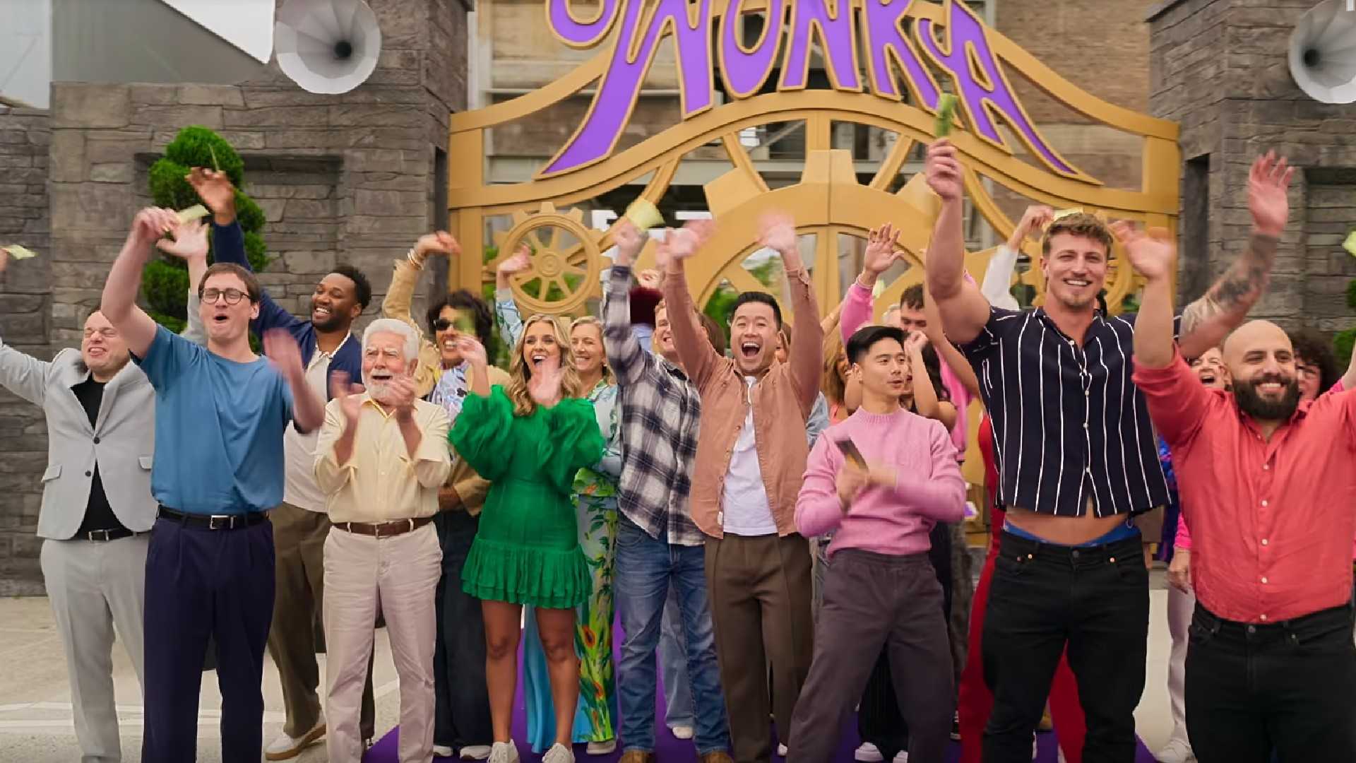 Wonka The Golden Ticket contestants waving and smiling outside the factory