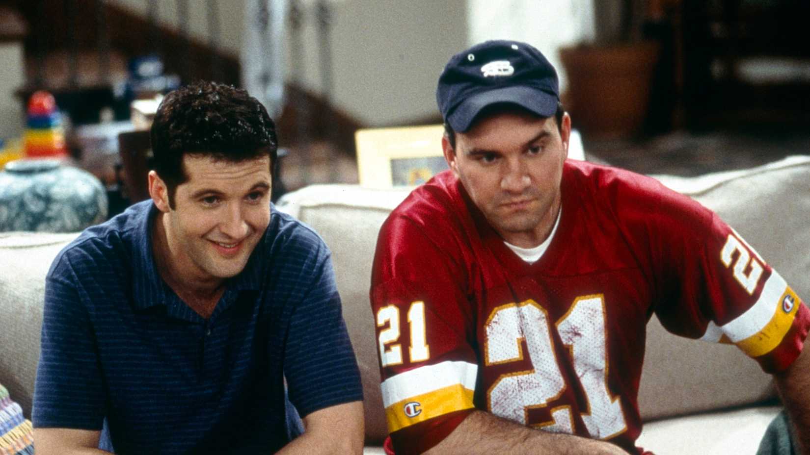 Two characters sitting on a couch in Yes, Dear sitcom
