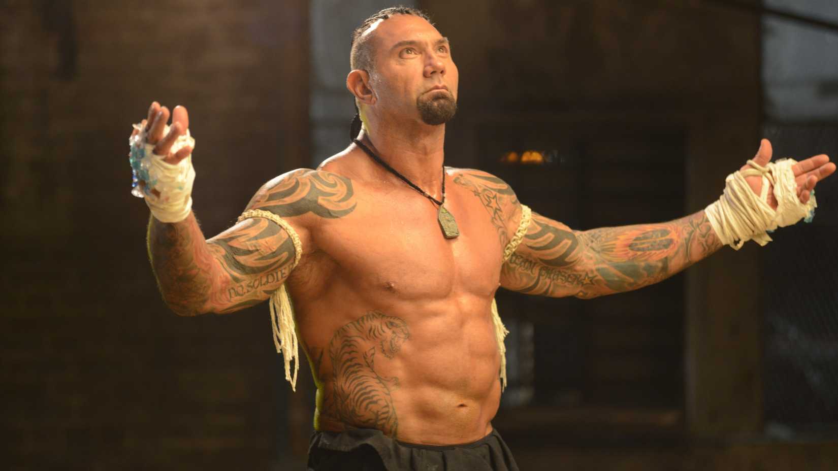 Dave Bautista’s Tong Po raising his hands in victory in Kickboxer