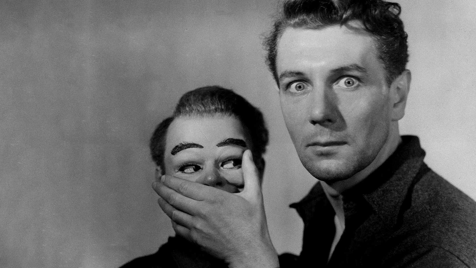 A man holds his hand over a dummy's mouth in Dead of Night 1945
