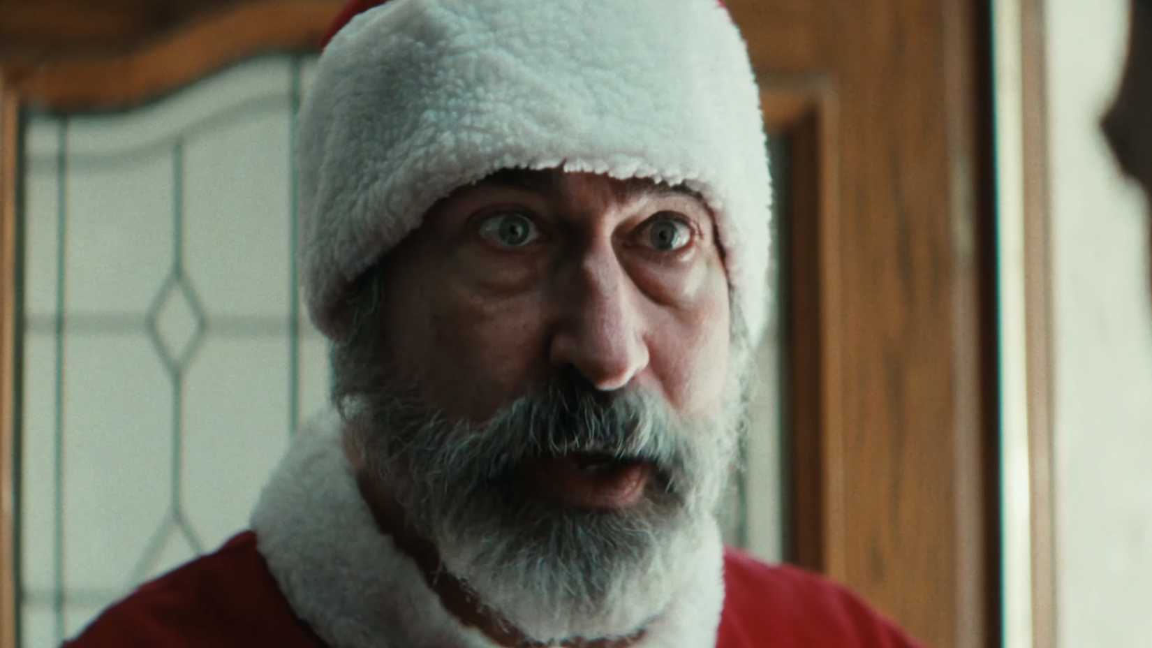A person dressed as Santa looking shocked in Christmas At The Kringles